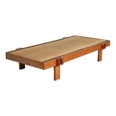 a small wooden table with two legs and a mattress on top of it, against a white background