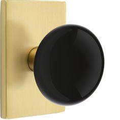 a black and gold door knob on a white background