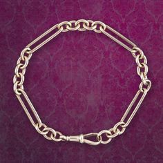 A stylish antique Victorian Albert chain bracelet made up of solid gold cable and trombone links that have developed a lovely rosy patina over time and are each stamped 375/ 9ct.   It has a good weight to it and was likely converted from an old Albert chain from the late 19th Century and is held by a classic claw clasp, stamped with the maker's mark.  WEIGHT: 19.4 grams    MEASURES: Length 8.6 inches x Width 6-7mm   METAL: 9ct Gold (Stamped)    AGE: Victorian. (Circa 1900)   MARKS: 375/ 9ct stam Classic Gold Oval Link Bracelet With Hooks, Classic Gold Bracelet With Oval Link, Classic Gold Chain Bracelet With Hooks And Links, Gold Chain Bracelet With Hooks And Links, Vintage Yellow Gold Chain Bracelet With Rectangular Links, Classic Hallmarked Gold Link Bracelet, Classic Hallmarked Gold Oval Link Bracelet, Classic Hallmarked Oval Link Chain Bracelet, Classic Hallmarked Chain Link Bracelet