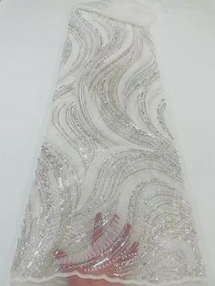 This high quality Fabric is measured in 5 Yards With Embroidered Beading and Sequin. It is soft, very delicate and beautiful. This high Quality Fabric is made with Fashion embroidered rhinestones can be used in making party wedding dresses, skirts, shawls, scarves and other other fashion apparels as you would like. Size : Length : 5 yards (180 inch). Width: 50 inch (Please allow slight deviation for the measurement data ,±1 inch) Material: 100% Polyester, Tulle Lace Fabric, Eco-Friendly embroide Elegant Embroidered Sequin Fabric For Wedding, Elegant White Beaded Embroidered Fabric, Elegant Silver Embroidered Fabric For Wedding, Elegant White Embroidered Beaded Fabric, Elegant White Embellished Sequin Fabric, White Pearl Embroidered Fabric For Party, Elegant White Embroidered Fabric With Sequins, Elegant Silver Embellished Embroidered Fabric, Elegant Wedding Sequin Fabric