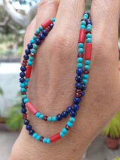 A Boho style Necklace made of multi gemstone.  We have Lapis Lazuli, Blue Turquoise, Matte Finished Red Coral(Sea Bamboo) and Garnet in this necklace. Width of the necklace is 4mm. (0.14")    Clasp is a 925 Sterling Lobster Clasp. Length is 17.5" or 44.5cm. Weight is 10 grams.  Stringing is on Soft Flex - Soft Touch 49 Strands beading wire for máximum strength and flexibility. Photos are close-up, so check actual size carefully. Color varies with monitor. Shipping is from the Canary Islands, Spain. (Please see Shipping & Policy) A Reminder:  Any of our listings on Solitary Mountain can be combined with any of our listings on Peridot Mountain. https://www.etsy.com/shop/PeridotMountain?ref=hdr_shop_menu Simply request Custom Listing. Yesterday climbed to the top of the volcano Guardilama, fr Lapis Lazuli Beaded Necklace, Southwestern Red Gemstone Jewelry, Southwestern Style Red Gemstone Jewelry, Traditional Hand-strung Blue Jewelry, Round Blue Turquoise Necklace For Healing, Blue Turquoise Necklace For Healing, Southwestern Blue Beaded Necklaces For Gift, Southwestern Blue Gemstone Necklace, Southwestern Style Blue Beaded Necklace For Gift