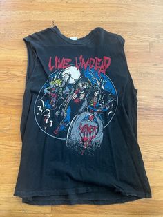 Rare out of print Slayer "Live Undead" sleeveless shirt from Madeworn. These are high end vintage replicas of old shirts, made to look and feel worn This Slayer shirt is long out of print. Size L. Sold as is! Vintage Sleeveless T-shirt With Graphic Print, Grunge Sleeveless Halloween Top, Sleeveless Grunge Halloween Tops, Sleeveless Grunge Tops For Halloween, Grunge Graphic Print Vest For Streetwear, Grunge Tank T-shirt For Streetwear, Punk Style Tank Top For Halloween, Graphic Tee With Vintage Print For Concert, Cotton Grunge Vest With Graphic Print