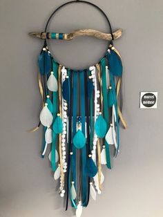 a blue and white dream catcher hanging on a wall