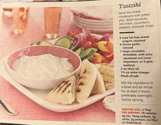 an article in a magazine about hummus and pita bread on a pink tablecloth