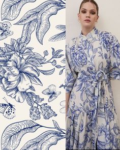 a woman standing next to a blue and white floral wallpaper