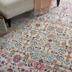 a living room with a couch and rug on the floor