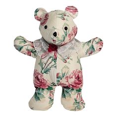 a white teddy bear with pink roses on it