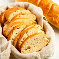 sliced bread in a basket next to a loaf of bread