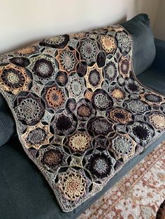 a crocheted blanket sitting on top of a couch