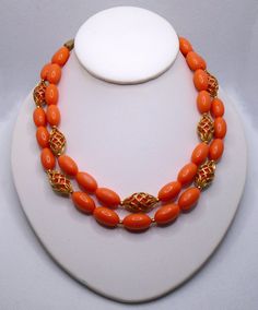 Vintage Textured Gold Tone Faux Coral Orange Beads and Gold Tone Caged Beads Double Strand Necklace.  The necklace is unmarked.  The necklace is adjustable with a hook closure and a maximum length of 16 inches.  Shipping via USPS Ground Advantage with Tracking and Insurance.  I am happy to combine shipping on multiple items.  Please feel free to contact me with any questions. Coral Jewelry Vintage, Coral Beads Necklace, Online Gold Jewellery, Beading Jewelery, Double Strand Necklace, Coral Jewelry, Vintage Texture, Neck Piece, Coral Orange