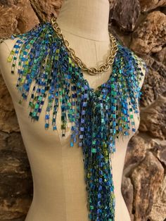 Turquoise, blue and green scarf necklace for women. Lightweight scarf for summer events or just to give a new look for simple t-shirts. Makes handy travel accessory, takes little room in your luggage and can replace jewelry. This ladder yarn scarf has gorgeous lime green and variegated blue turquoise with metallic gold. Brings Caribbean vacation to your mind. Colors glisten in sunshine like little beads, absolutely breathtaking color combination for any occasion.  Hand wash in lukewarm water with mild soap, don't rub or wring, squeeze off excess water and hang to dry. Warm iron is ok if needed.  Comes with nice organza satchel for traveling or gift giving. I recommend storing the ribbon scarves on a hanger or on a hook or flat in a drawer. Handmade in United States of America.  Visit the s Trendy Blue Scarf As Gift, Trendy Blue Scarf For Gift, Trendy Blue Scarves For Gifts, Blue Necklace For Summer Parties, Green Necklaces For Summer Parties, Scarf For Summer, Cruise Accessories, Ladder Yarn, Yarn Scarf