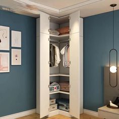 an open closet with blue walls and pictures on the wall