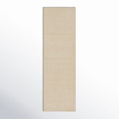 a beige rug with vertical lines on the bottom, and a white wall in the background