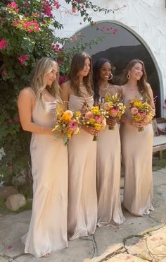 the bridesmaids are all dressed in different colors