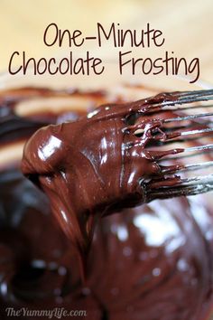 a glass bowl filled with melted chocolate on top of a wooden table