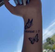 a woman's arm with a butterfly tattoo on it