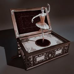 a ballerina figure is standing in an open box on a table with its legs spread out