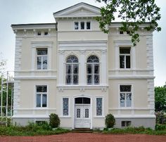 a large white building with many windows and doors