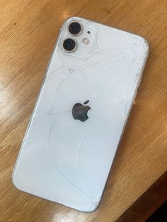 an apple phone sitting on top of a wooden table