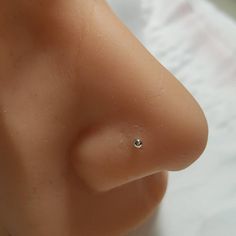 a close up view of a fake nose with a diamond in it's center