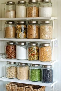 an organized pantry filled with lots of different types of food and cereals in glass jars