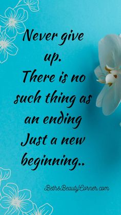 a white flower sitting on top of a blue table next to a quote that says never give up there is no such as an ending just a new beginning