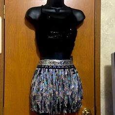 Nwt From Boohoo A Fun And Flirty 2 Piece Festival Outfit. Outfit Is 2 Pieces Consisting Of A Skirt And Top. Skirt Is Silver Sequin Pieces Tattered And Layered. Crop Tie Tank Top In Black Sequins...Lace Up And Ties In The Back. Sexy And Festive And Perfect For Summer Events!!! Its Waiting On You! Size 10. Fitted Silver Skirt For Club, Silver Fitted Skirt For Club, Silver Embellished Skirt For Night Out, Fitted Silver Disco Skirt, Silver Fitted Disco Skirt, Fitted Disco Evening Skirt, Glamorous Fitted Skirt For Festival, Fitted Silver Skirt For Party, Silver Fitted Skirt For Party