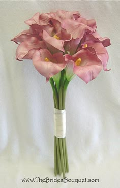 a bouquet of pink flowers in a white vase