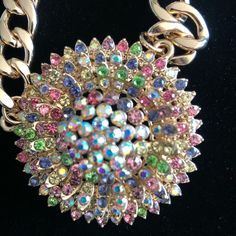 Natasha Gold Tone Rhinestone Round Flower Shaped Pendant Necklace. The Gold Tone Chain Is Heavy And Extends From 21” To 24” With A 3” Extender. Lobster Claw Clasp The Pendant Is About 2.5” Wide And It Has Beautiful Colorful Sparkling Crystals. This Is A Stunning Piece That Could Be A Perfect Gift For Someone Special. Multicolor Rhinestone Necklace With Sparkling Stones For Party, Multicolor Crystal Rhinestone Necklace With Sparkling Stones, Multicolor Crystal Rhinestone Costume Necklace, Multicolor Crystal Rhinestone Necklace, Multicolor Rhinestone Necklace With Jewels, Costume Jewelry, Multicolor Rhinestone Necklace Costume Jewelry, Party Jeweled Rhinestone Necklace, Elegant Multicolor Rhinestone Necklace With Bling, Party Rhinestone Jeweled Necklace