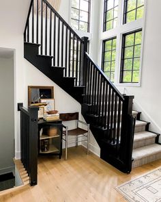 the stairs in this house are made of wood and have been painted black with white trim