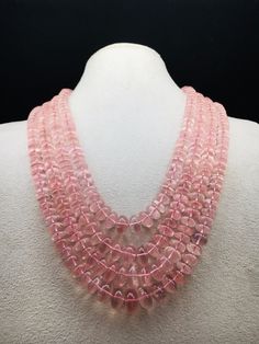 100% Natural Rose Quartz smooth rondelle shape beaded necklace with adjustable silk cord closure.  Details: - Gemstone - Rose Quartz Shape - Rondelle Gross weight - 1073.75 carat Net weight - 1033.00 carat Length - Inner - 15 inches, Outer - 19 inches Calibration of beads - 8.00 millimeters till 14.00 millimeters SKU - HJSPSAR0033 100% NATURAL ROSE QUARTZ AMAZING NECKLACE UNIQUE NECKLACE PINK COLOR NECKLACE Thank you for your kind visit to my shop. NOTE: - You will receive the same product you see in the picture.   Dear Buyers, please feel free to ask questions    We will be glad to answer & solve query regarding this product RETURN POLICY: -   Every piece of jewelry and inputs ( gemstones, diamonds, making, and setting) is tested by our team of experts and experienced  artisans to generat Luxury Pink Briolette Necklace, Luxury Pink Oval Necklace, Rose Quartz Necklace With Faceted Round Beads, Rose Quartz Faceted Beads Necklace, Pink Polished Round Bead Necklaces, Pink Round Polished Bead Necklaces, Luxury Single Strand Pink Jewelry, Luxury Pink Single Strand Jewelry, Elegant Rose Quartz Round Crystal Necklaces