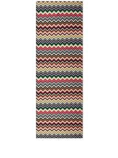 a multicolored rug with wavy stripes