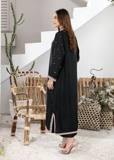 Black pure Boski silk kurta handworked with nude pink resham and mirrorwork details on the neckline, sleeves, front and back of the shirt (Includes shirt only)