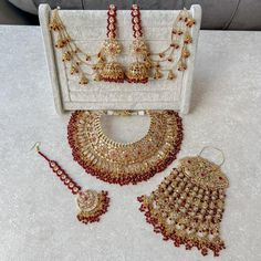 Flexible Gold plated luxury necklace set made up of of champagne zircon crystals, tiny champagne and maroon crystal beads. Necklace comes complete with matching tikka, and earrings and matching large jhumar. Necklace is adjustable to fit any size.  Ready to ship as seen with gift box. Maroon Bridal Jewellery Set, Maroon Crystal, Maroon Necklace, Crystal Beads Necklace, Gold Bangles Indian, Indian Wedding Jewelry Sets, Perhiasan India, Bridal Jewellery Design, Necklace Set Indian