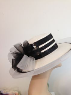 Woman's White Straw Hat with Black Bow and Sequin Trim. 5 Rows of Black and White Sequin around Crown of hat.  Outer brim has 2 rows of black and white sequins with synthetic trim. Bow is sheer Black and White at back. The straw and trim is 100 % Polypropylene.    Lovely Hat.  reminds me of Audrey Hepburn in My Fair Lady, just needs a few more trims. Circumference is 22 Inches (Interior).  Height of Crown is 3 1/2 Inches.   Cartwheel Style -  53 Inch Outer Circumference Ideal for Special Occasion, Tea, Kentucky Derby, or Costume. .. White Fedora Costume Hat For Summer, White Fedora Mini Hat For Party, White Fitted Hat Bands For Party, Spring Party Visor Hat, White Party Hat Bands, White Fitted Fedora Mini Hat, White Sun Hat For Summer Evenings, White Hat Bands For Spring Party, White Summer Sun Hat For Evening