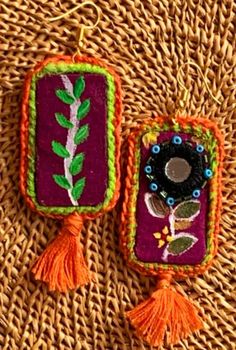 two small handmade items sitting on top of a woven mat