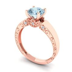 a rose gold engagement ring with an aqua blue topazte and diamonds on the side