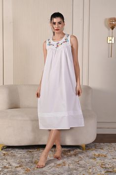 Embrace effortless elegance with our cotton poplin white sleeveless nightgown, beautifully adorned with intricate hand embroidery work. Crafted from soft, breathable cotton poplin, this nightgown offers a lightweight and airy feel, perfect for warm nights or relaxing days. The delicate embroidery adds a touch of sophistication, enhancing the timeless charm of the crisp white fabric. With a sleeveless design that allows for freedom of movement, this nightgown is ideal for lounging or drifting off Embroidered Summer Nightgown, Floral Embroidery Nightgown For Summer Daywear, Summer Floral Embroidered Nightgown For Daywear, Floral Embroidered Summer Nightgown For Daywear, Floral Embroidered Nightgown For Daywear In Summer, Floral Embroidered Nightgown For Summer Daywear, White Cotton Sleepwear With Floral Embroidery, White Summer Nightgown For Hospital, Nightgown Short