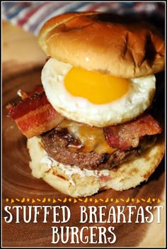 a bacon and egg breakfast burger on a bun with the words stuffed breakfast burgers