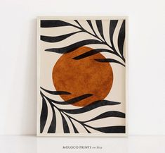 an orange circle is surrounded by black and white stripes on a square tile wall hanging