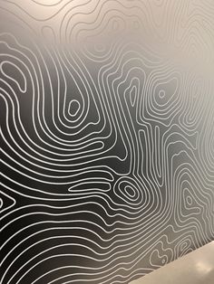 a wall with lines drawn on it next to a toilet