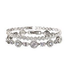 This medium weight bracelet set is decorated with delicate cubic zirconia pave crystals that will have you in the spotlight on your wedding day- and many days to come. This bracelet set looks great stacked or worn separately. Available in: 18K White Gold / Gold / Rose Gold over base metal Cubic Zirconia crystals Fold Over Clasp Hypoallergenic, lead, and nickel free Sophia Halo CZ Tennis Barcelet Silver B224 - Length: 6.5in (16.5cm) x Width: 0.4in (1cm) Regal Tennis Bracelet B245 - Length: 6.75in Halo Bracelet, Bracelet Set Silver, Cubic Zirconia Bracelet, Crystal Jewelry Sets, Diamond Necklace Set, Back Necklace, Bridal Bracelet, In The Spotlight, Crystal Drop Earrings