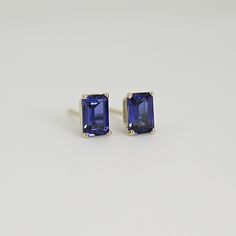 Elevate your style with our 14k Gold Emerald Cut Blue Sapphire Stud Earrings, perfect for adding a touch of sophistication and elegance to any outfit. These emerald cut sapphire stud earrings are the perfect size for everyday wear or special occasions, and their brilliant blue color is sure to catch the eye and make a statement. These exquisite studs feature genuine sapphire gemstones that are lab-grown for a sustainable and ethical choice. Unlike simulated or CZ stones, lab-grown sapphires are Elegant Octagon 14k Gold Earrings, Blue Emerald Cut Earrings For Formal Occasions, Classic Octagon Gemstone Earrings, Octagon 14k Gold Fine Jewelry Earrings, 14k Gold Octagon Fine Jewelry Earrings, Modern Emerald Cut Gemstone Earrings, Modern Emerald Cut Earrings For Gift, Classic Baguette Cut Gemstone Earrings, 14k Gold Sapphire Gemstone Earrings