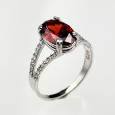 Add a touch of elegance and sophistication to your jewelry collection with this stunning sterling silver ruby women's ring. The vibrant red ruby gemstone is beautifully set in the sterling silver band, creating a timeless and eye-catching piece that is perfect for everyday wear or special occasions. This ring is the perfect gift for any woman who loves classic and elegant jewelry. Upgrade your style with this gorgeous sterling silver ruby women's ring today! Material : 925 Sterling Silver Gemsto Elegant Ruby Ring With Diamond Settings, Elegant Red Crystal Gemstone Ring, Elegant Garnet Gemstone Ring, Silver Ruby Ring With Gemstone Accents For Promise, Elegant Formal Birthstone Ring With Stone Setting, Elegant Red Crystal Ring For Formal Occasions, Elegant Red Ruby Open Ring, Elegant Birthstone Ring For Formal Occasions, Elegant Red Sterling Silver Ring