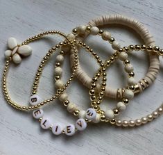 Ivory & Gold Bracelet Stack Heishi Bead Bracelet Stack - Etsy Bohemian Beige Stretch Bracelet As Gift, White Wooden Beads Stretch Bracelet As Gift, White Wooden Beads Stretch Bracelet Gift, White Stretch Bracelet With Wooden Beads For Gift, Cream Round Bead Bracelets For Everyday, Everyday Cream Beaded Bracelets, White Beaded Bracelets With Wooden Beads For Jewelry Making, Cream Beaded Bracelets With Round Beads For Gift, Adjustable Cream Jewelry With Wooden Beads