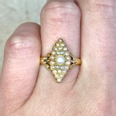 A stunning antique Georgian era navette ring featuring a cluster of seed pearls. This ring is handcrafted in 18k yellow gold. We estimate that this ring was crafted circa 1815.
The measurements of this ring are 16.85mm x 8.14mm.
This ring can be resized to any finger size at no extra cost.
If you have any questions about the Harrisburg Ring, please feel free to contact us. Antique Yellow Gold Pearl Ring With Rose Cut Diamonds, Victorian Multi-stone Yellow Gold Diamond Ring, Victorian Yellow Gold Cluster Diamond Ring, Victorian Cluster Yellow Gold Diamond Ring, Victorian Cluster Diamond Ring In Yellow Gold, Antique Gold Cluster Ring With Multi-stone, Antique Yellow Gold Pearl Ring, Antique Yellow Gold Oval Pearl Ring, Antique Oval Yellow Gold Pearl Ring