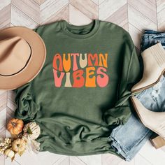 Looking for a cute versatile top to wear? Make sure to grab one of our Graphic Sweatshirts! This soft and comfortable shirt is the perfect top for any outfit. It can be paired with biker shorts, Jeans, or the classic stay at home sweats! This sweatshirt is true-to-size, so be sure to order your regular size! If you are looking for a more oversized look, make sure to size up. Trendy Green T-shirt For Fall, Cozy Letter Print Tops For Spring, Cozy Graphic Print Tops For Spring, Graphic Print Tops For Fall Loungewear, Fall Letter Print Top For Loungewear, Graphic Print Tops For Loungewear In Fall, Letter Print Lounge Tops For Fall, Letter Print Top For Fall Loungewear, Cute Oversized Fall Tops