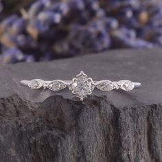 a diamond ring sitting on top of a rock