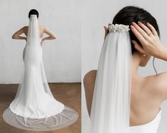 a woman in a white wedding dress is holding her veil over her head and looking back at the camera