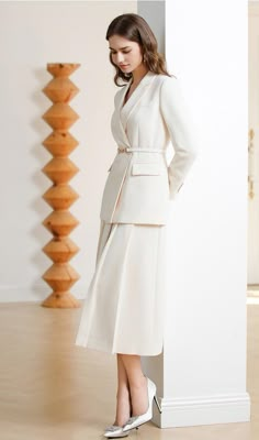 Introduce the "Chic Ivory Duo: Loose-Fit Blazer and Skirt Ensemble" – the ultimate blend of poise and practicality. Tailored for those who lead with elegance and command every room they enter. Product Description: Discover the essence of modern professionalism with our "Chic Ivory Duo: Loose-Fit Blazer and Skirt Ensemble". The ensemble features a luxurious loose-fit blazer with meticulous tailoring that drapes effortlessly for a comfortable yet authoritative look. The matching skirt, with its flowy A-line cut, sits gracefully at knee-length, providing a harmonious balance to the relaxed fit of the blazer. Finished in a serene ivory shade, this set exudes a soft power perfect for the office or formal events. The blazer is detailed with a subtle lapel and discreet button closure, while the s Ivory Work Dress, Skirt Formal Outfit, Skirt Blazer Outfit, Skirt And Blazer Outfit, Suits With Skirts, Formal Skirt Outfit, Blazer Work Outfit, Blazer Over Dress, Dress With Blazer Outfit